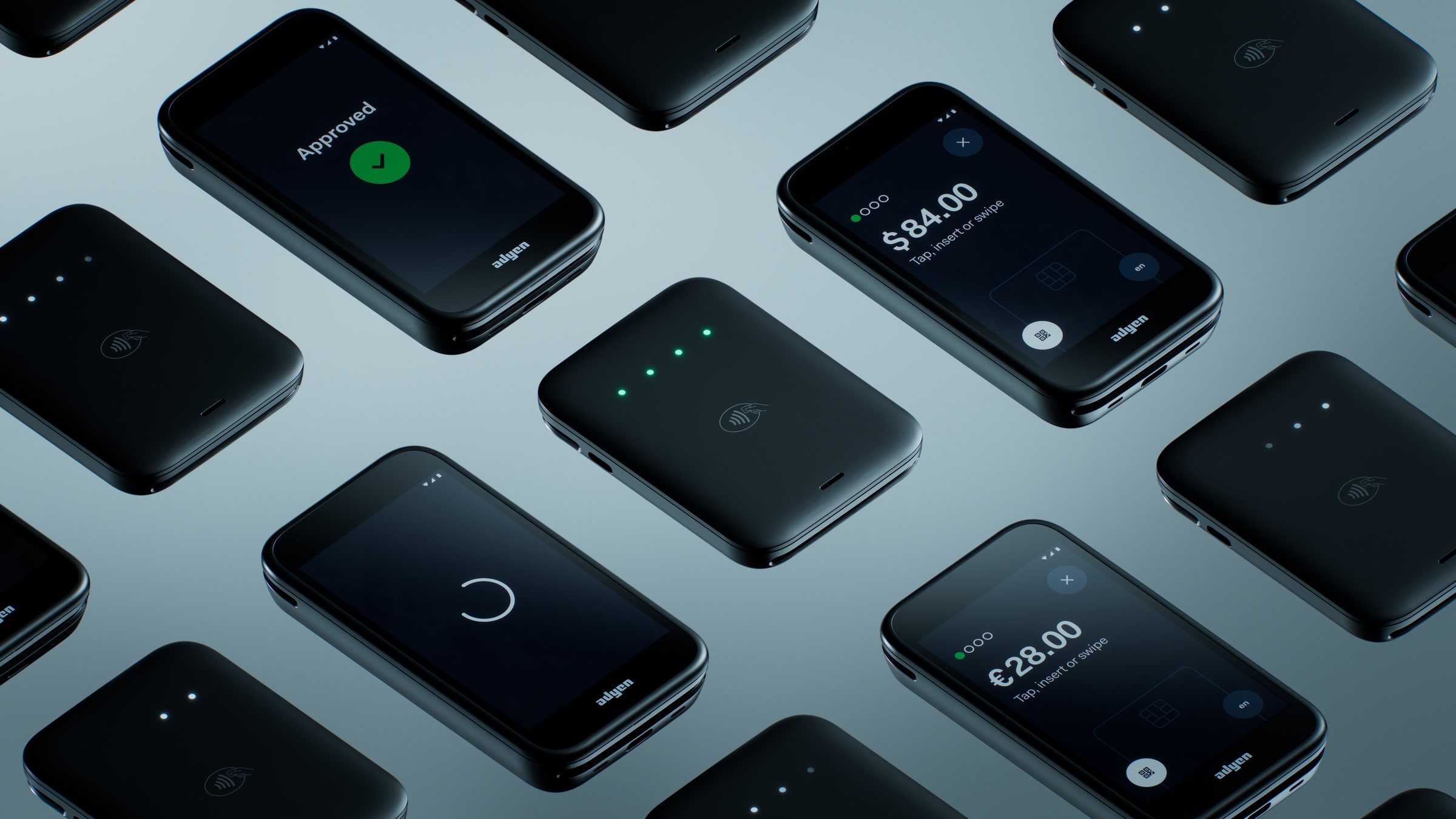 Rows of Adyen AMS1 payment devices, some showing payment screens for $84.00, $28.00 and an approved payment